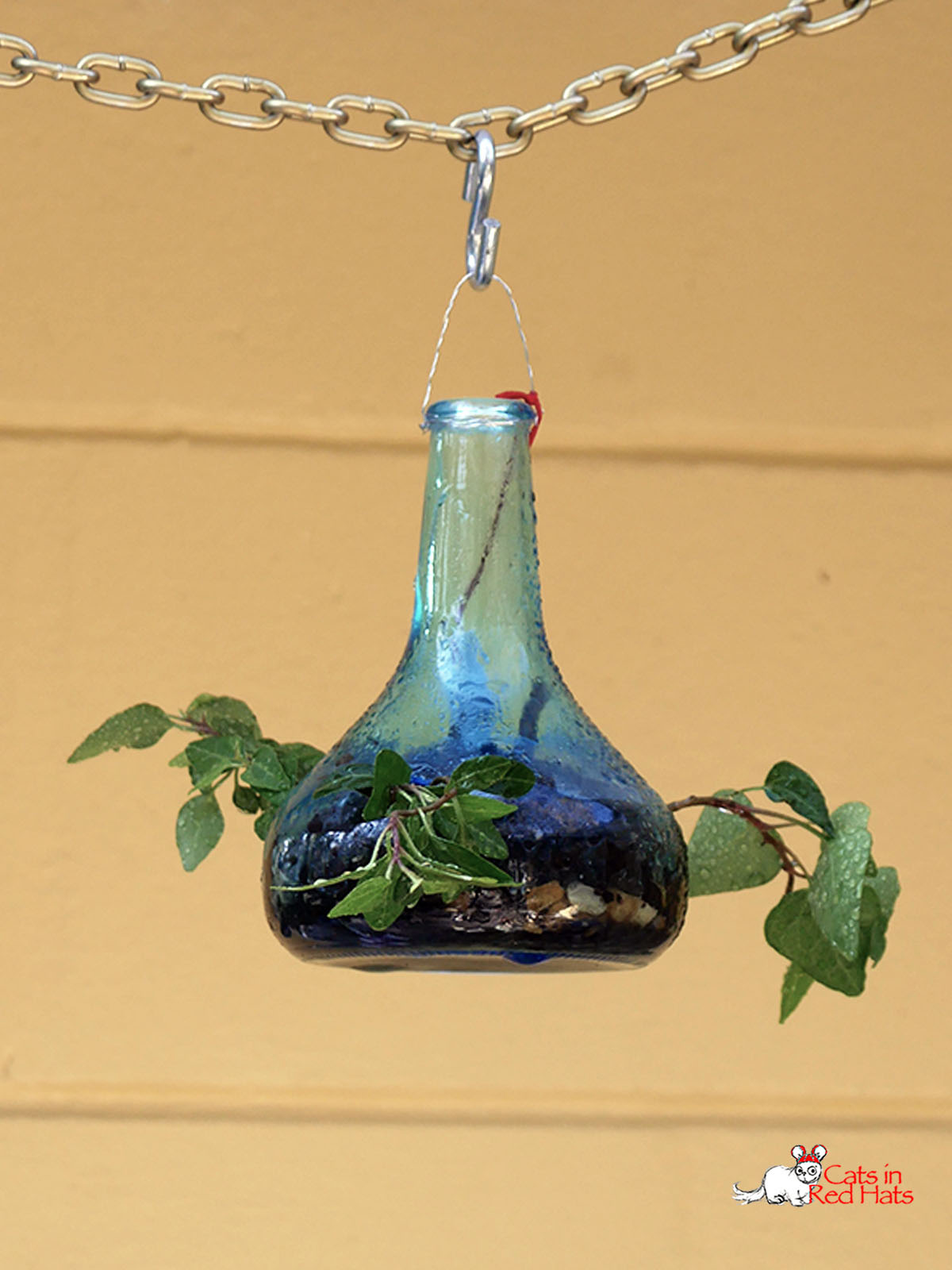Small blue tear shaped Cold Saki bottle with holes in side for plants